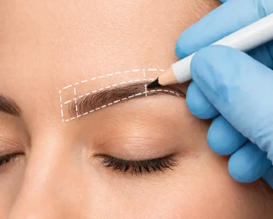 Doctor marking eyebrow transplant design on woman for eyebrow hair restoration